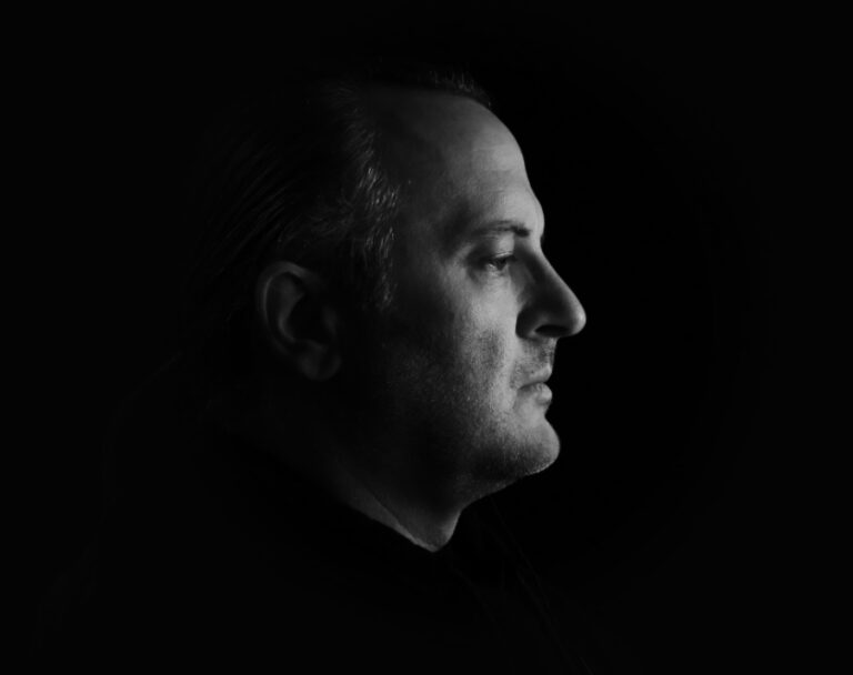 Black & White Profile Shot of Brian against a Black Background